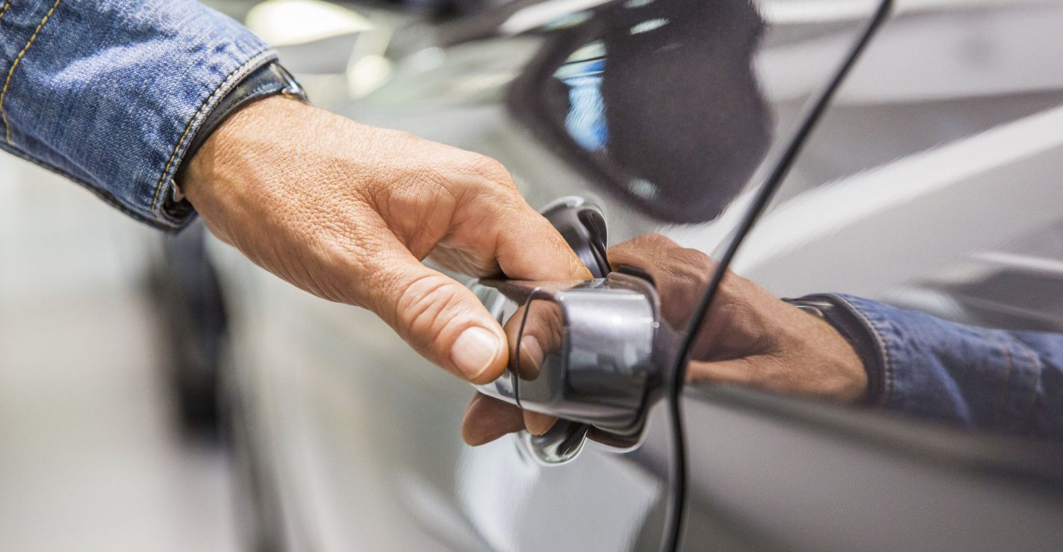 mans-hand-on-grey-car-door-handle-royalty-free-image-1636479509